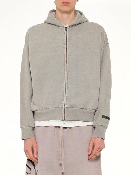 Image of a model wearing Outerwear. Product name - Classic Full Zip Hoodie in Smoke Grey colour by brand - FEAR OF GOD ESSENTIALS