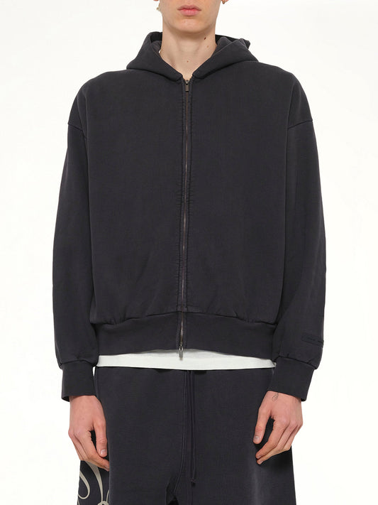 Image of a model wearing Outerwear. Product name - Classic Full Zip Hoodie in Black colour by brand - FEAR OF GOD ESSENTIALS
