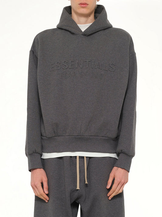 Image of a model wearing Outerwear. Product name - Classic Hoodie in Charcoal Heather colour by brand - FEAR OF GOD ESSENTIALS