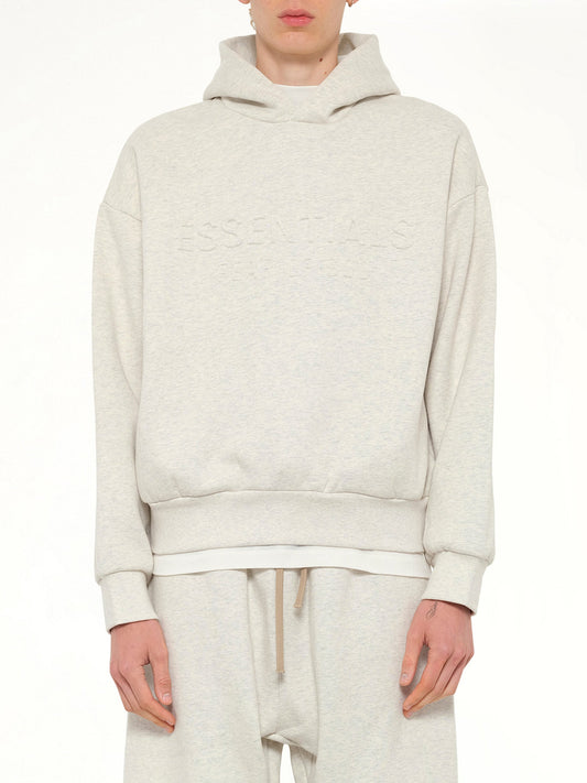 Image of a model wearing Outerwear. Product name - Classic Hoodie in Beige colour by brand - FEAR OF GOD ESSENTIALS