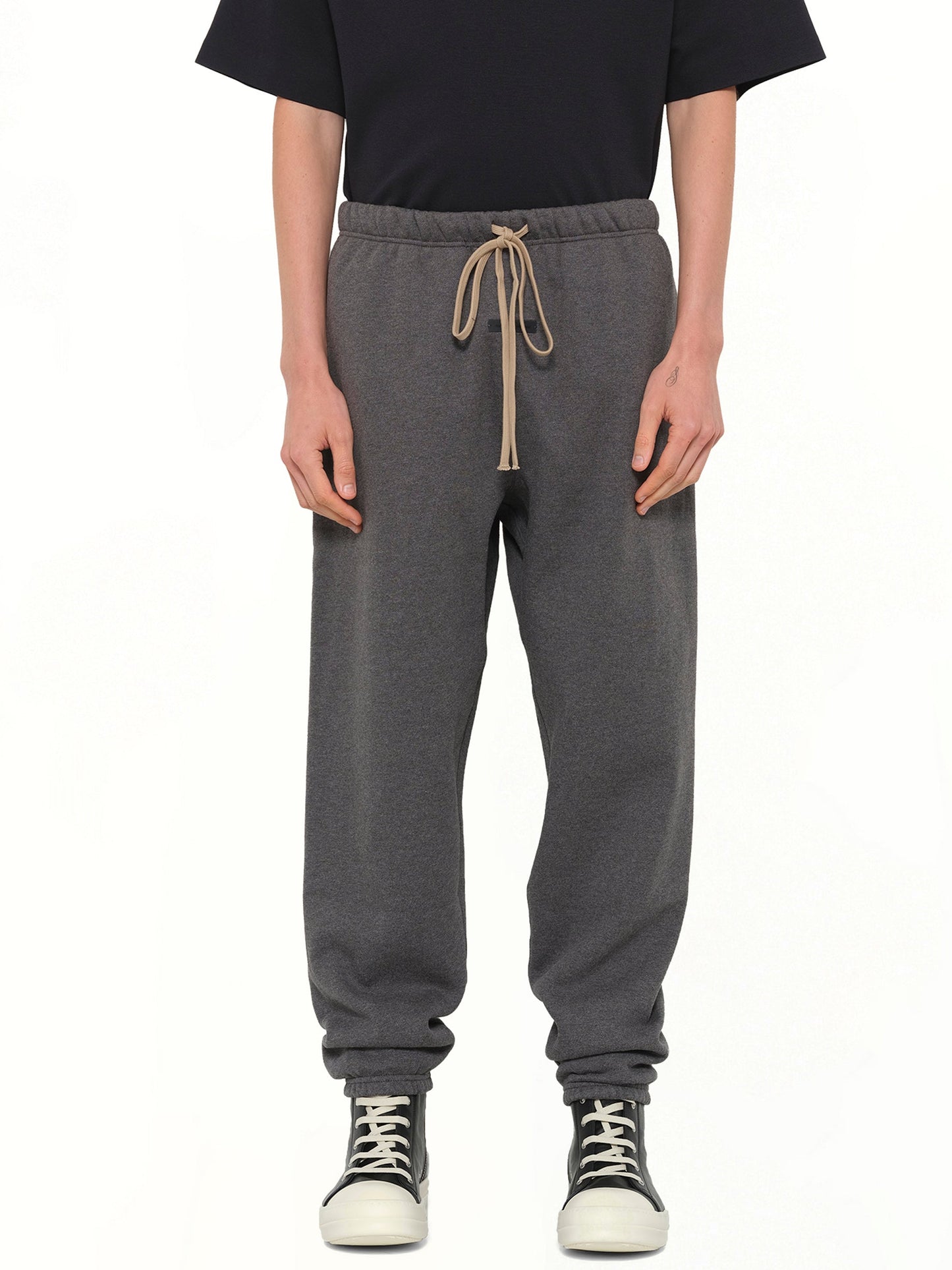 Image of a model wearing Pants. Product name - Classic Sweatpant in Charcoal Heather colour by brand - FEAR OF GOD ESSENTIALS