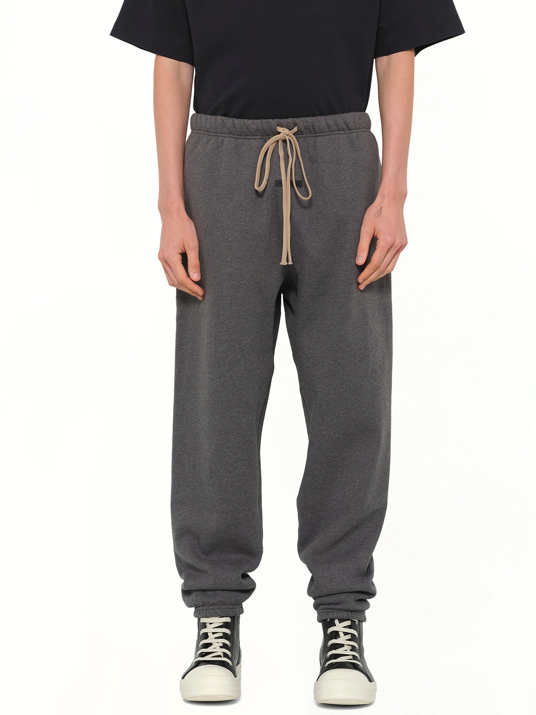 Image of a model wearing Pants. Product name - Classic Sweatpant in Charcoal Heather colour by brand - FEAR OF GOD ESSENTIALS