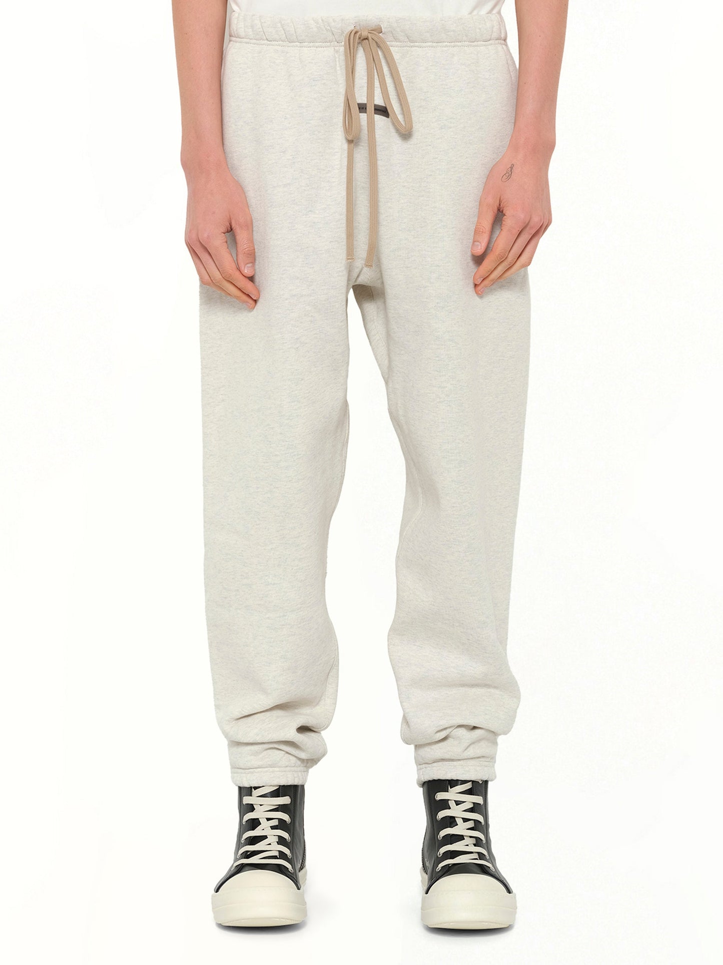 Image of a model wearing Pants. Product name - Classic Sweatpant in Beige colour by brand - FEAR OF GOD ESSENTIALS