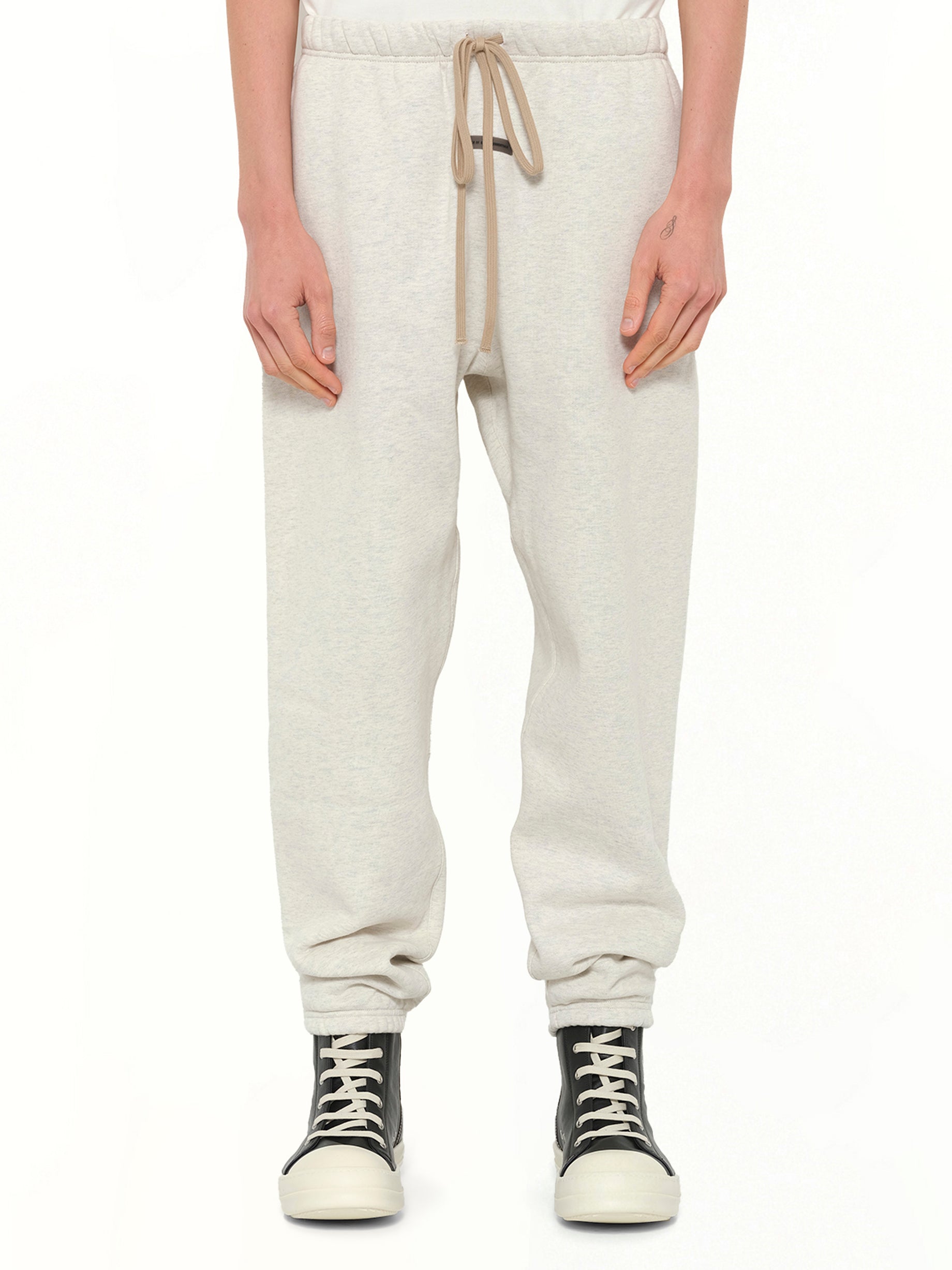 Image of a model wearing Pants. Product name - Classic Sweatpant in Beige colour by brand - FEAR OF GOD ESSENTIALS