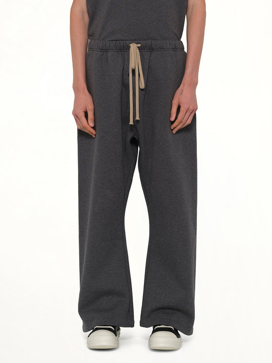 Image of a model wearing Pants. Product name - Flare Sweatpant in Charcoal Heather colour by brand - FEAR OF GOD ESSENTIALS