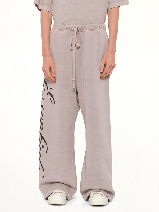 Image of a model wearing Pants. Product name - Lounge Sweatpant in Smoke Grey colour by brand - FEAR OF GOD ESSENTIALS