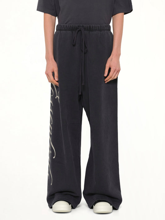 Image of a model wearing Pants. Product name - Lounge Sweatpant in Black colour by brand - FEAR OF GOD ESSENTIALS
