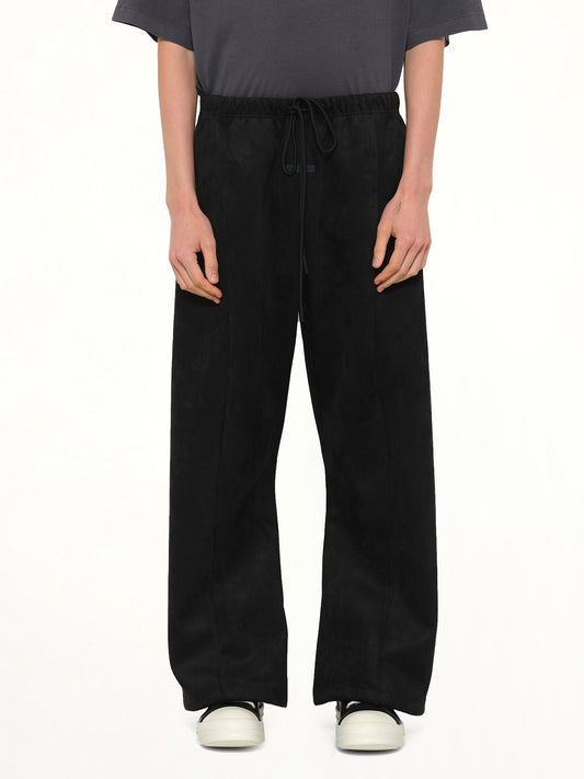 Image of a model wearing Pants. Product name - Flare Pant in Black colour by brand - FEAR OF GOD ESSENTIALS