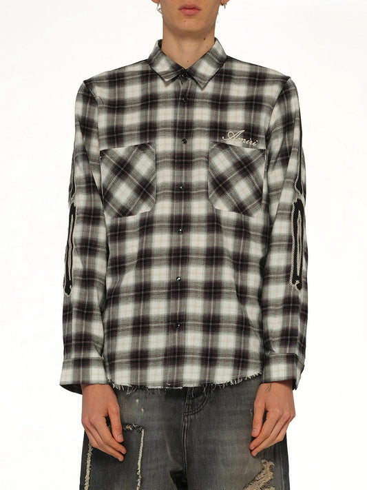 Image of a model wearing Tops. Product name - Bones Flannel Overshirt in Black colour by brand - AMIRI