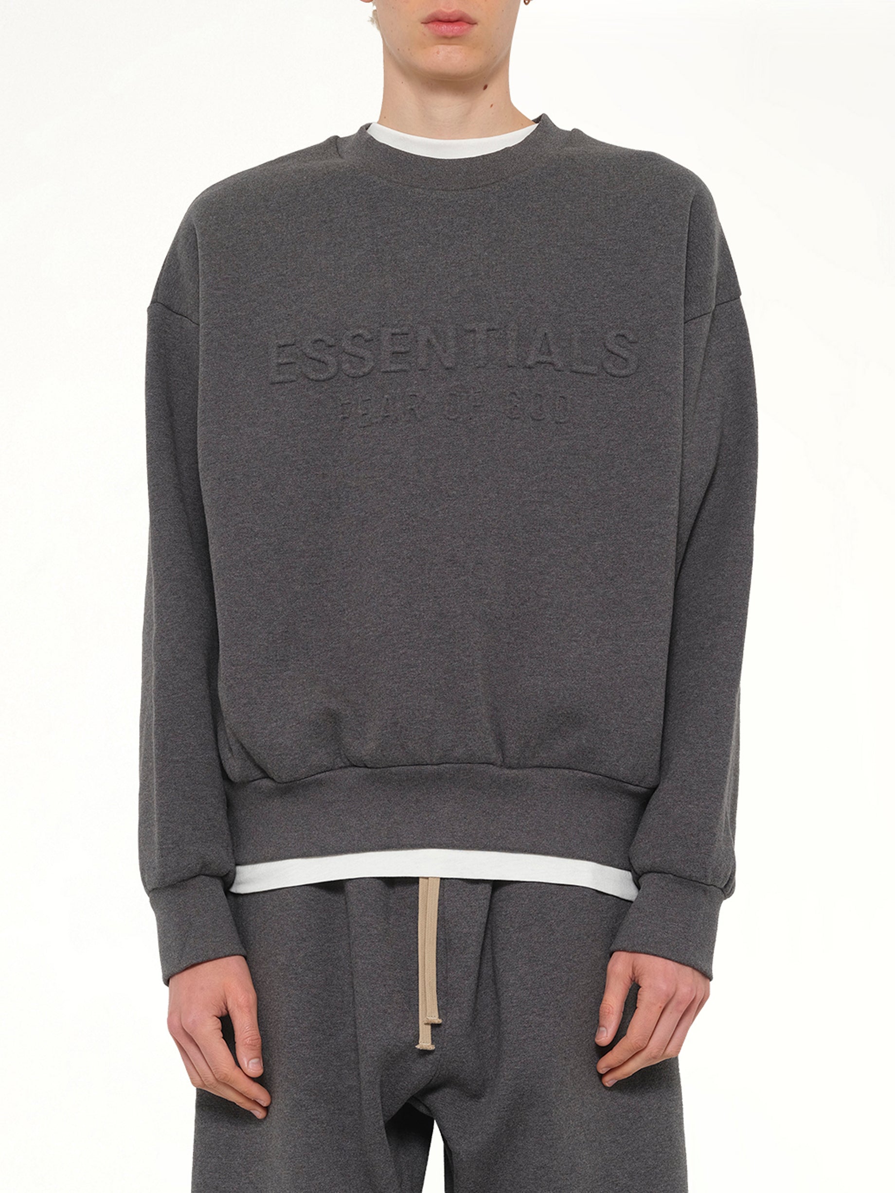 Image of a model wearing Outerwear. Product name - Classic Crewneck Sweatshirt in Charcoal Heather colour by brand - FEAR OF GOD ESSENTIALS