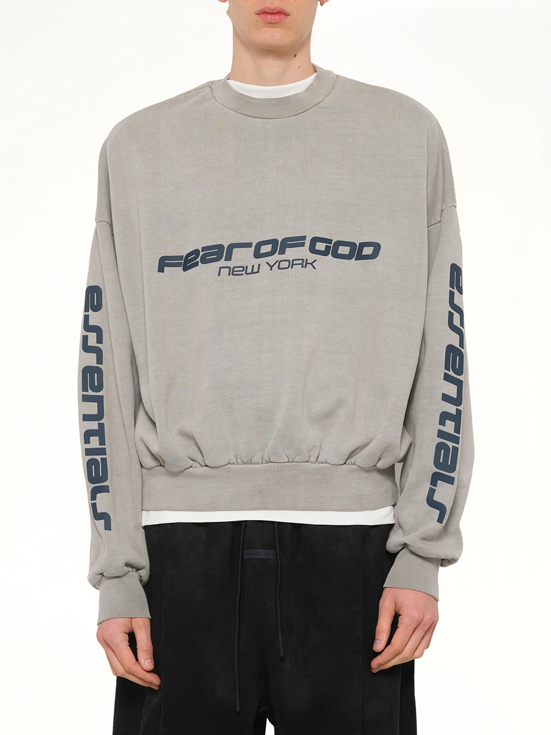 Image of a model wearing Outerwear. Product name - Cropped Relaxed Sweatshirt in Smoke Grey colour by brand - FEAR OF GOD ESSENTIALS