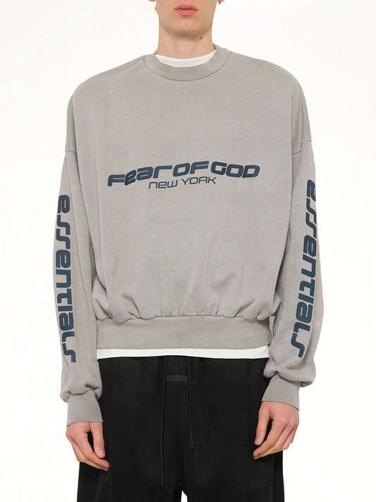 Image of a model wearing Outerwear. Product name - Cropped Relaxed Sweatshirt in Smoke Grey colour by brand - FEAR OF GOD ESSENTIALS
