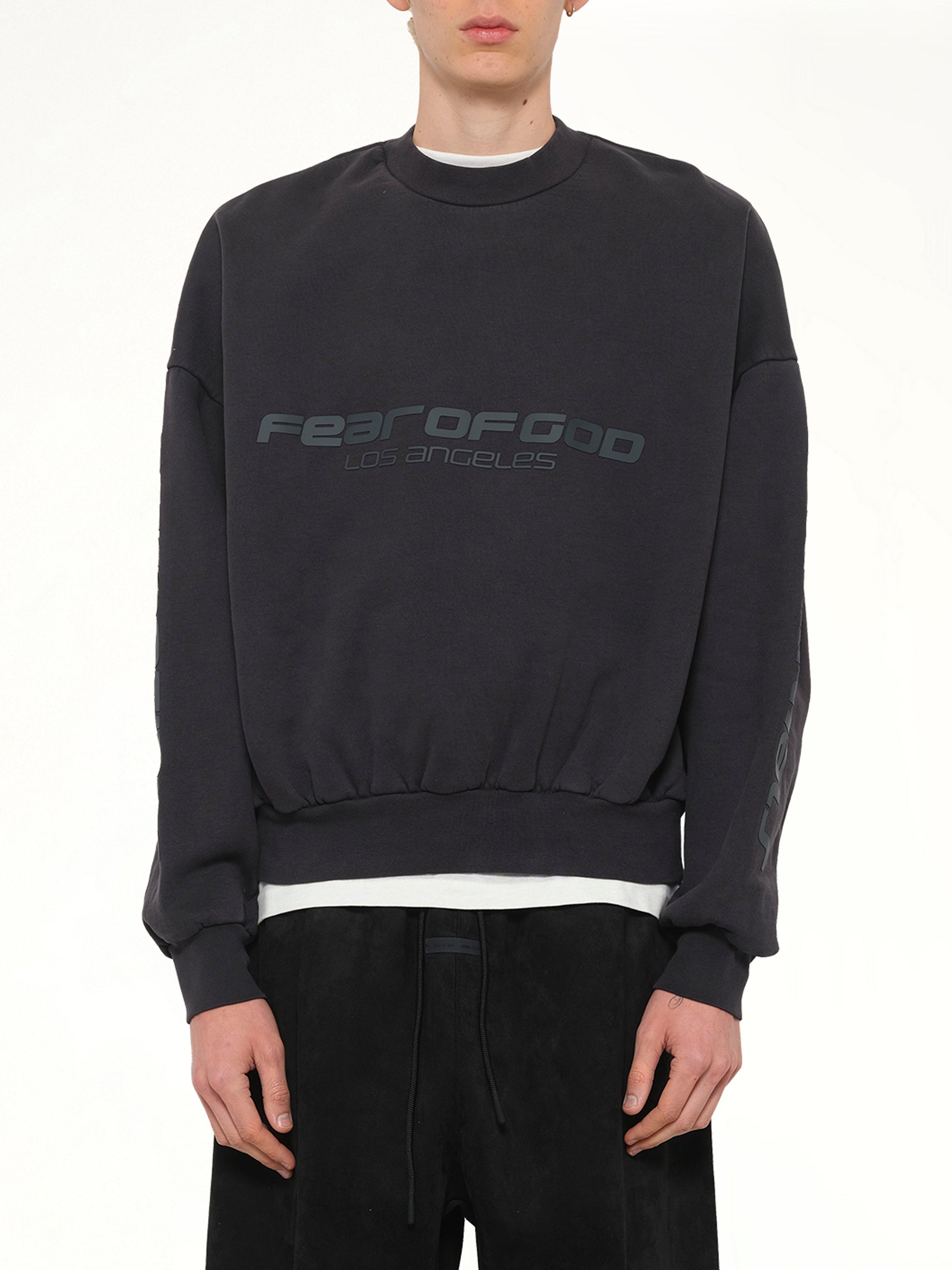 Image of a model wearing Outerwear. Product name - Cropped Relaxed Sweatshirt in Black colour by brand - FEAR OF GOD ESSENTIALS