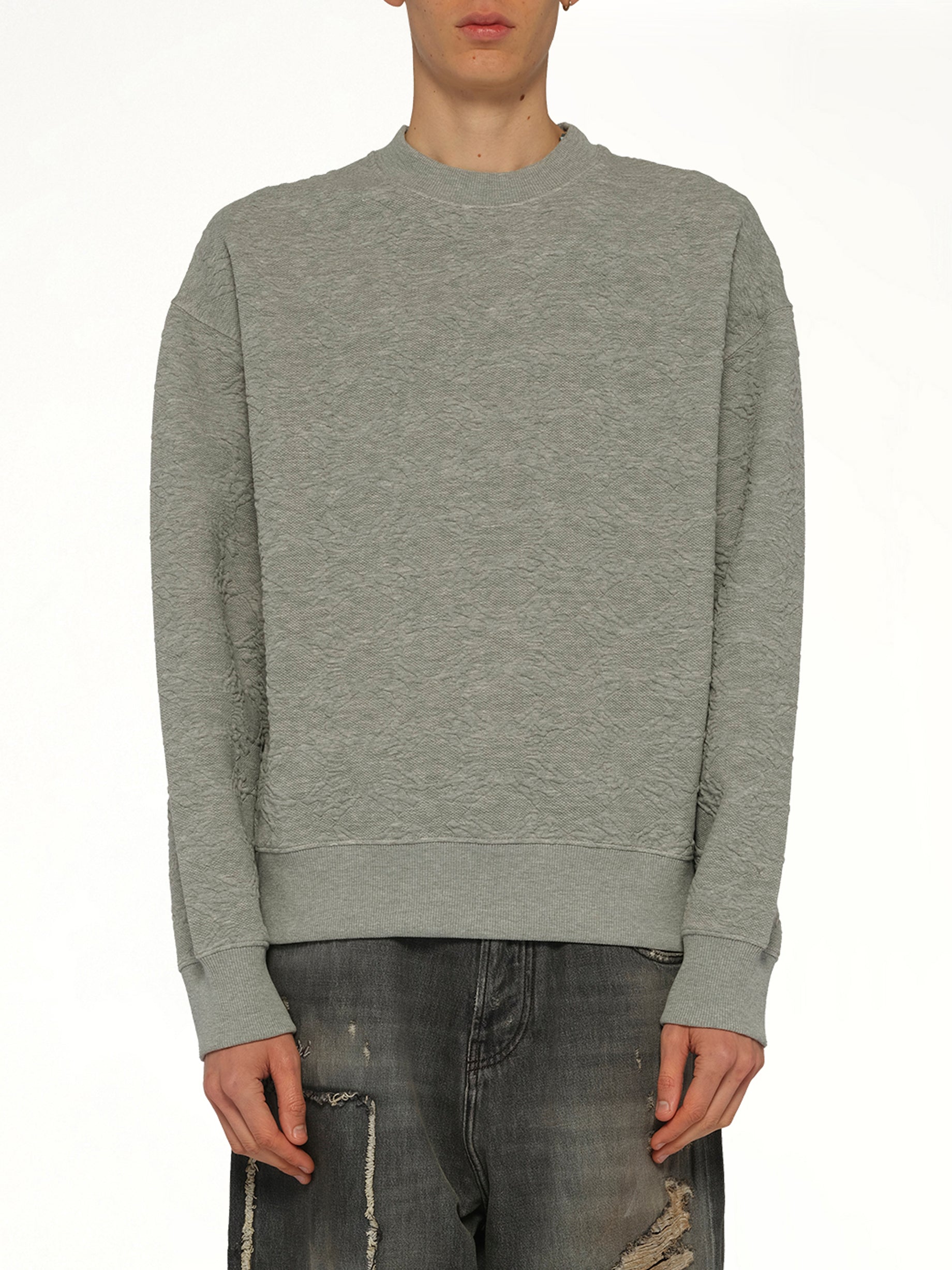 Image of a model wearing Outerwear. Product name - MA Quad Oversized Sweatshirt in Grey colour by brand - AMIRI