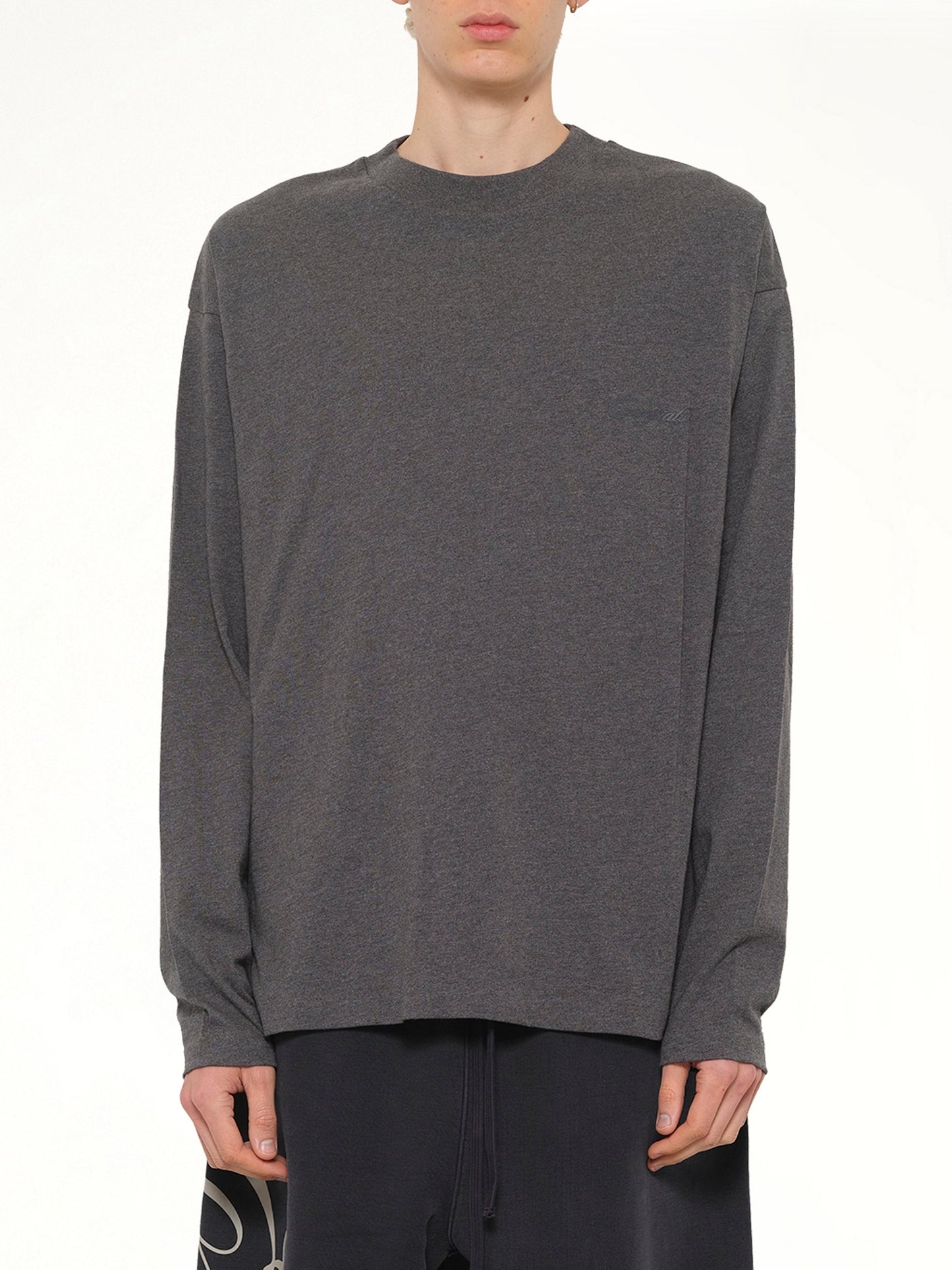 Image of a model wearing Tops. Product name - Classic Long Sleeve T-Shirt in Charcoal Heather colour by brand - FEAR OF GOD ESSENTIALS