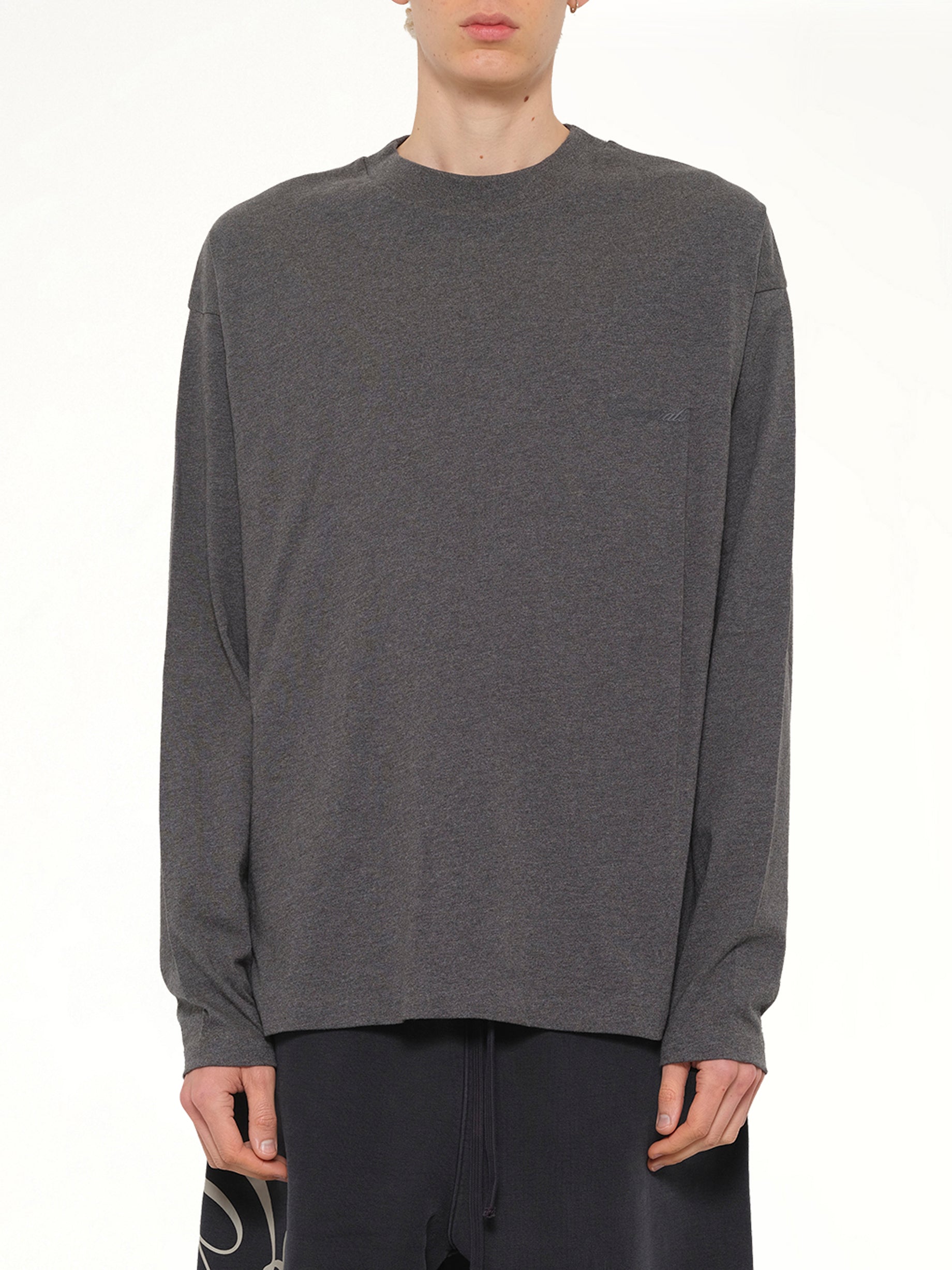 Image of a model wearing Tops. Product name - Classic Long Sleeve T-Shirt in Charcoal Heather colour by brand - FEAR OF GOD ESSENTIALS