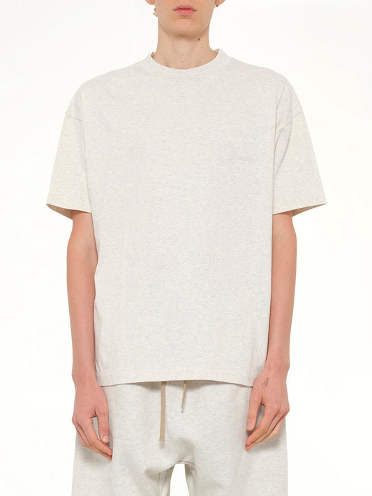 Image of a model wearing Tops. Product name - Classic Short Sleeve T-Shirt in Beige colour by brand - FEAR OF GOD ESSENTIALS