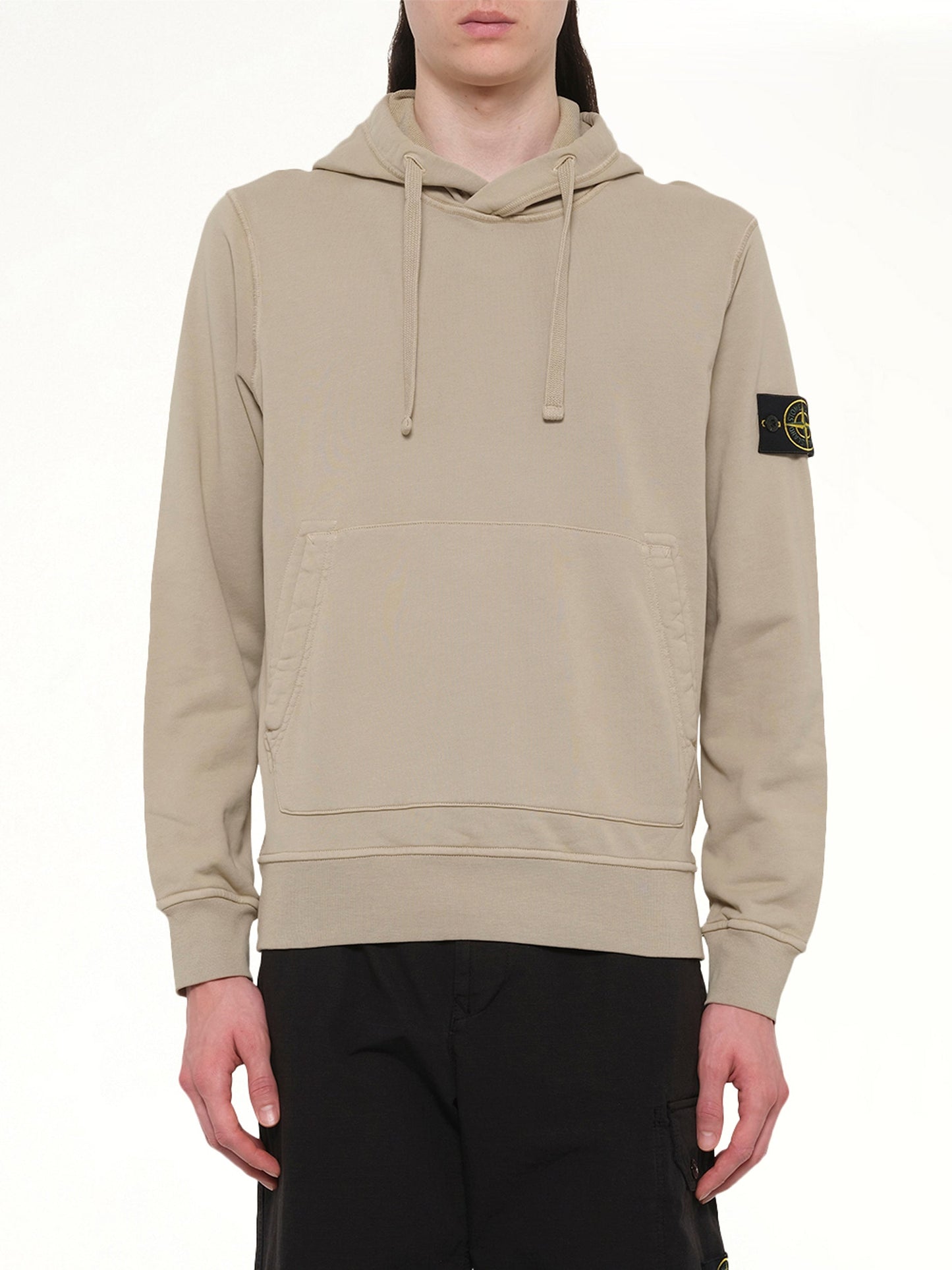 Image of a model wearing Outerwear. Product name - 610006 Cotton Fleece Hoodie in Desert colour by brand - STONE ISLAND