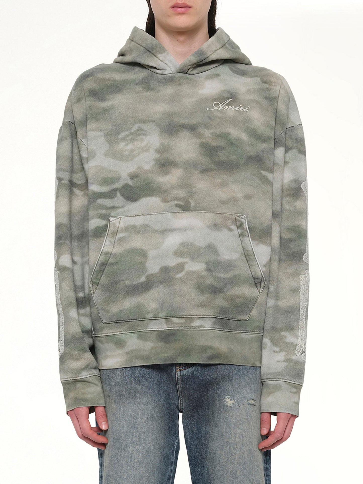 Image of a model wearing Outerwear. Product name - Bones Oversized Hoodie in Camo colour by brand - AMIRI
