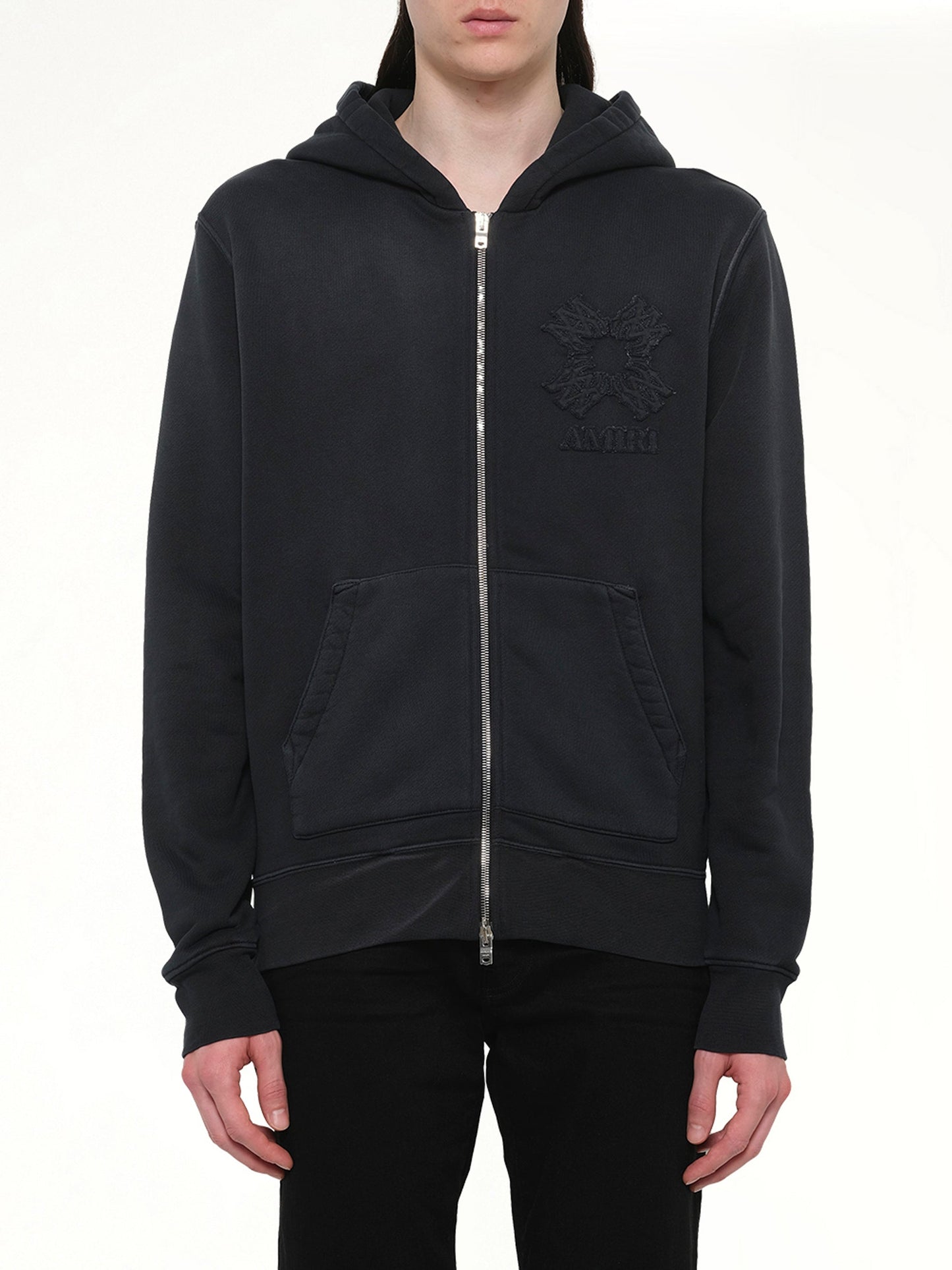 Image of a model wearing Outerwear. Product name - MA Quad Zip Hoodie in Black colour by brand - AMIRI