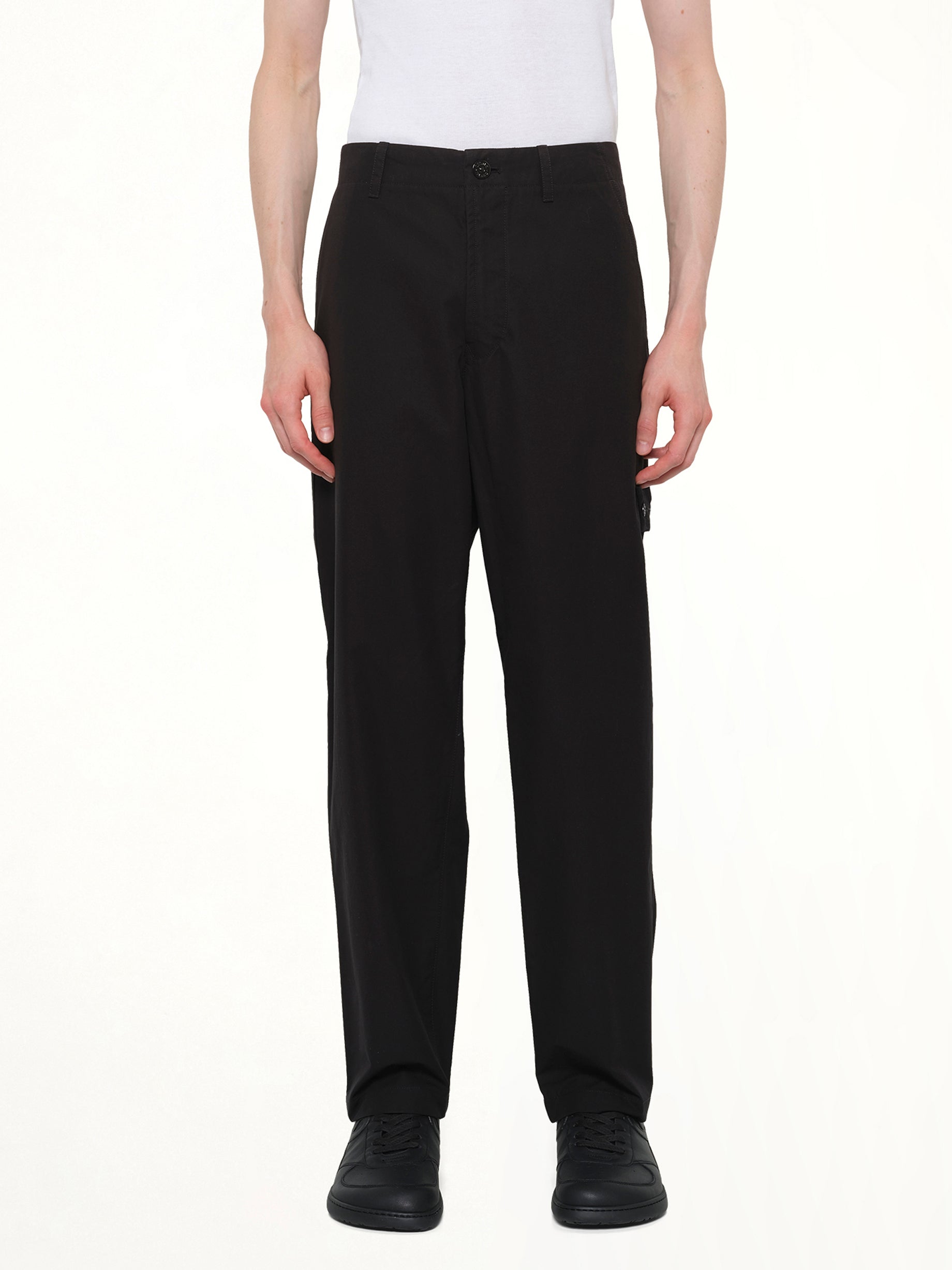 Image of a model wearing Pants. Product name - 310004 Weatherproof Trousers in Black colour by brand - STONE ISLAND