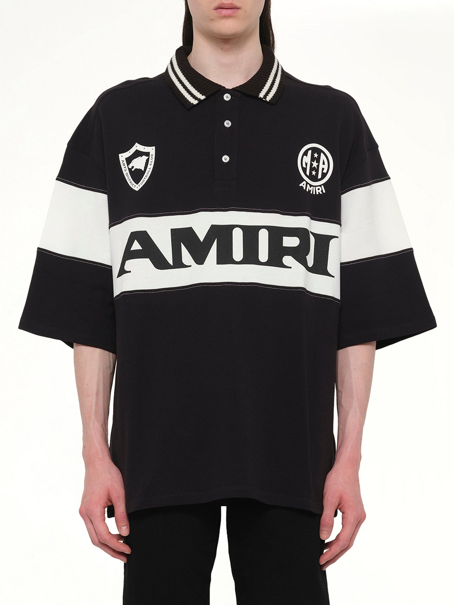 Image of a model wearing Tops. Product name - Amiri Sport Oversized Polo in Black colour by brand - AMIRI