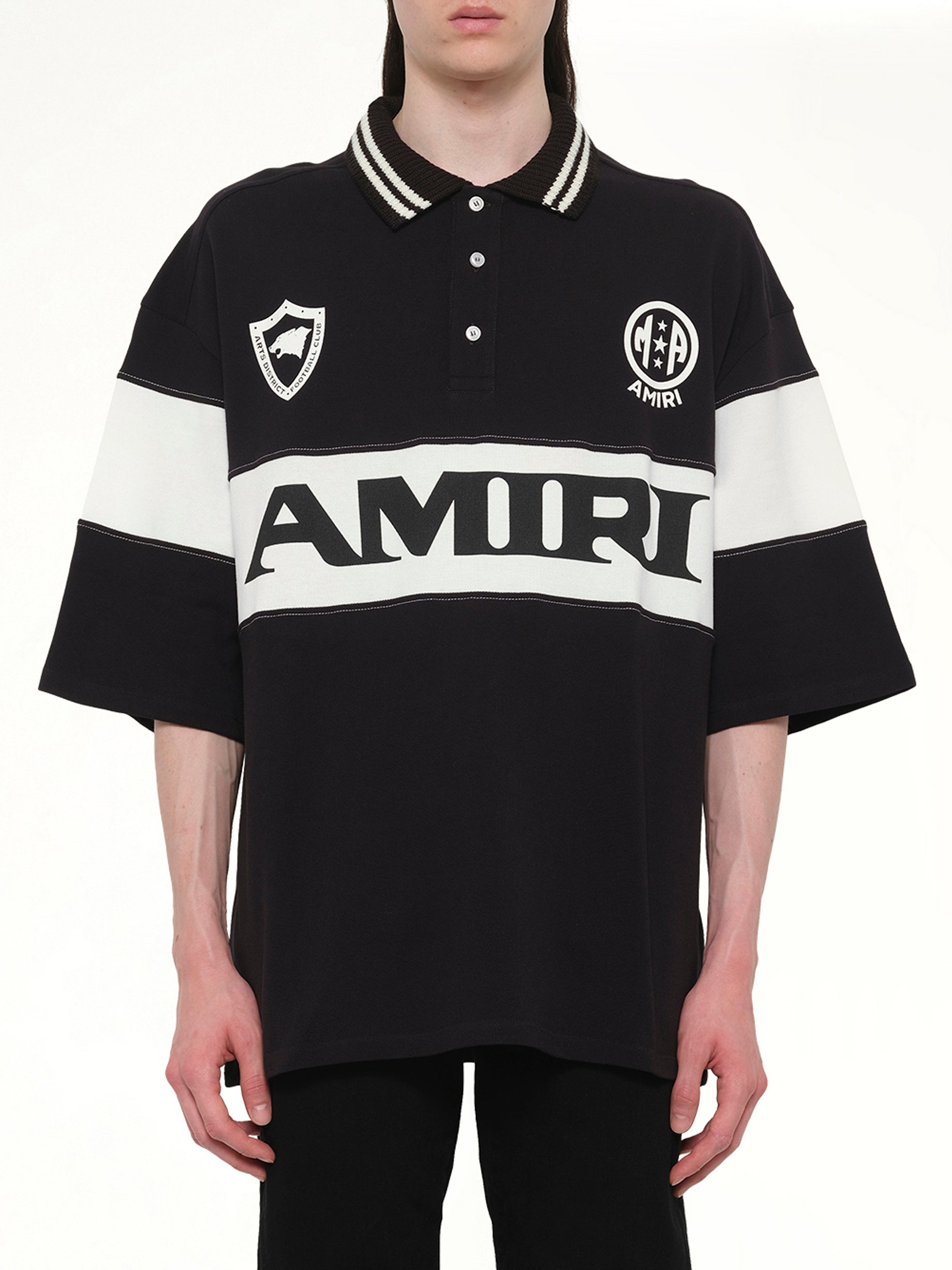 Image of a model wearing Tops. Product name - Amiri Sport Oversized Polo in Black colour by brand - AMIRI