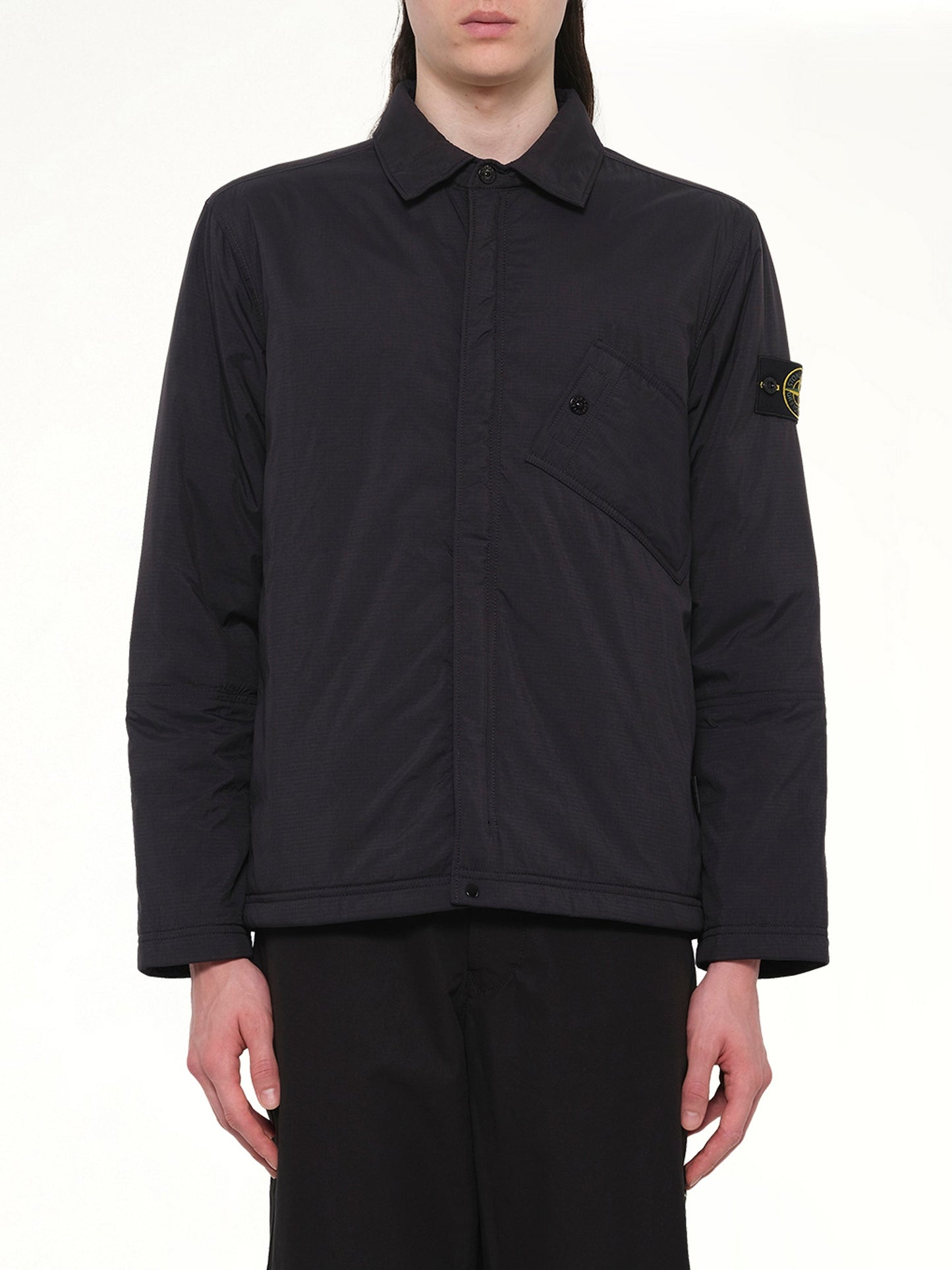 Image of a model wearing Tops. Product name - 1200007 Overshirt in Black colour by brand - STONE ISLAND