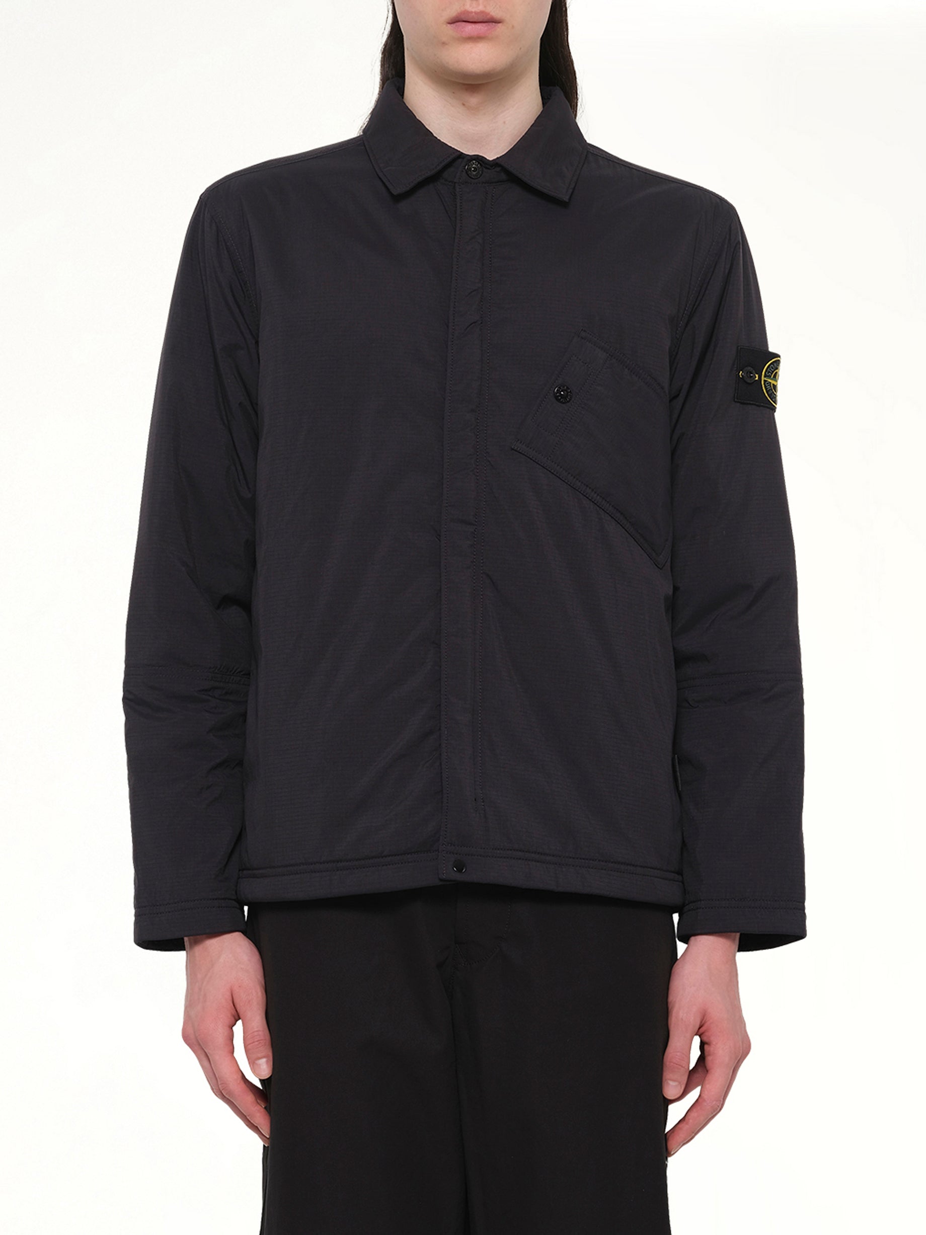Image of a model wearing Tops. Product name - 1200007 Overshirt in Black colour by brand - STONE ISLAND