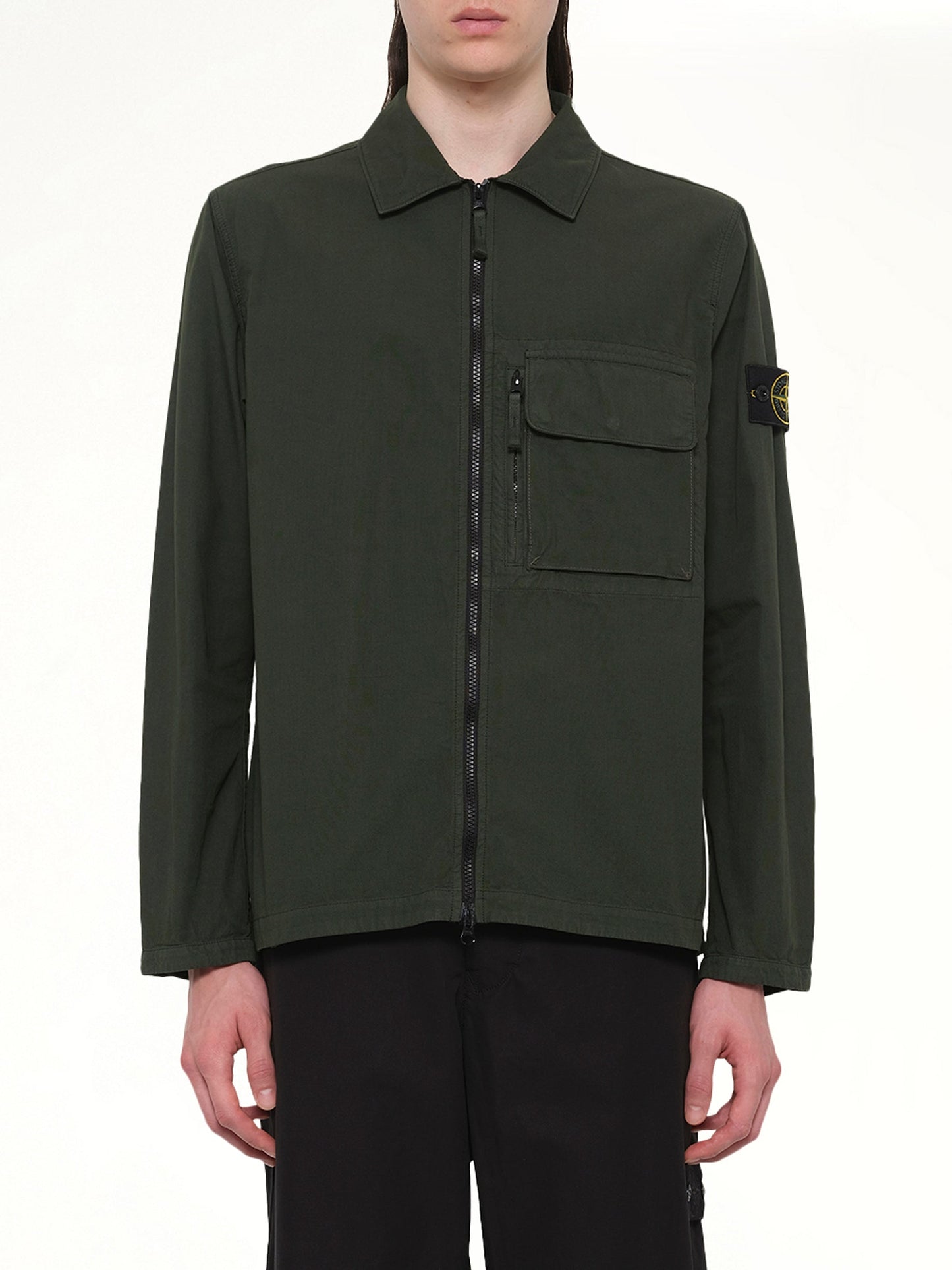 Image of a model wearing Tops. Product name - 120000 Overshirt in Juniper colour by brand - STONE ISLAND
