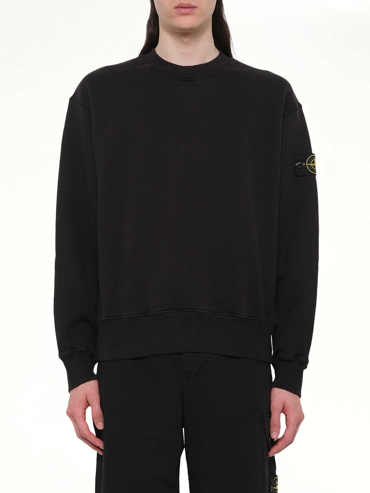 Image of a model wearing Outerwear. Product name - 610002 Heavy Cotton Fleece Sweatshirt in Black colour by brand - STONE ISLAND