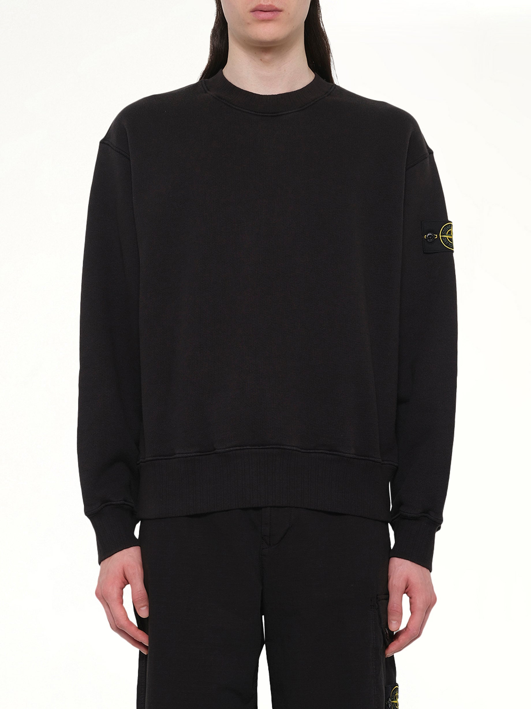 Image of a model wearing Outerwear. Product name - 610002 Heavy Cotton Fleece Sweatshirt in Black colour by brand - STONE ISLAND