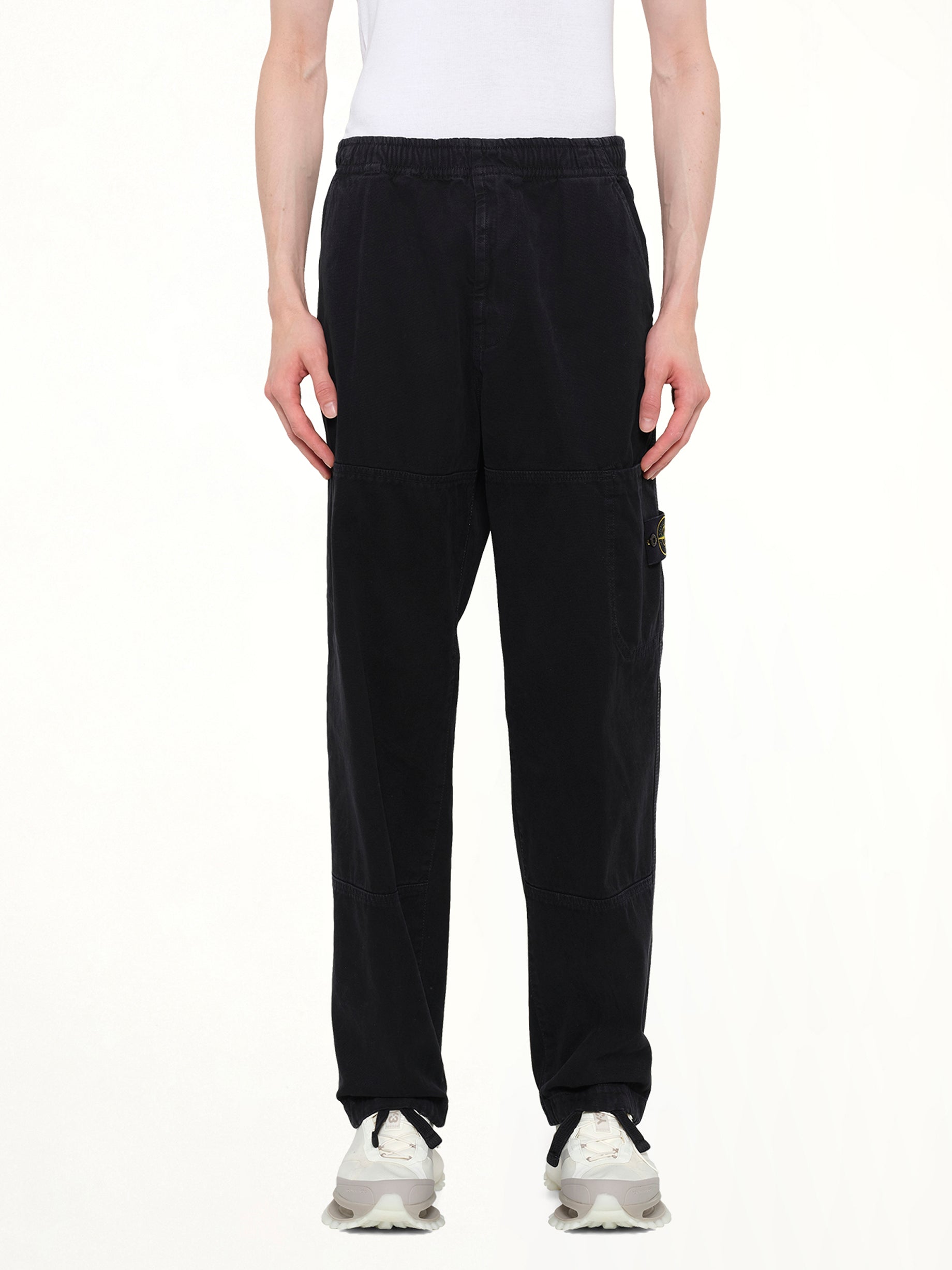 Image of a model wearing Pants. Product name - 3100005 Trousers in Black colour by brand - STONE ISLAND
