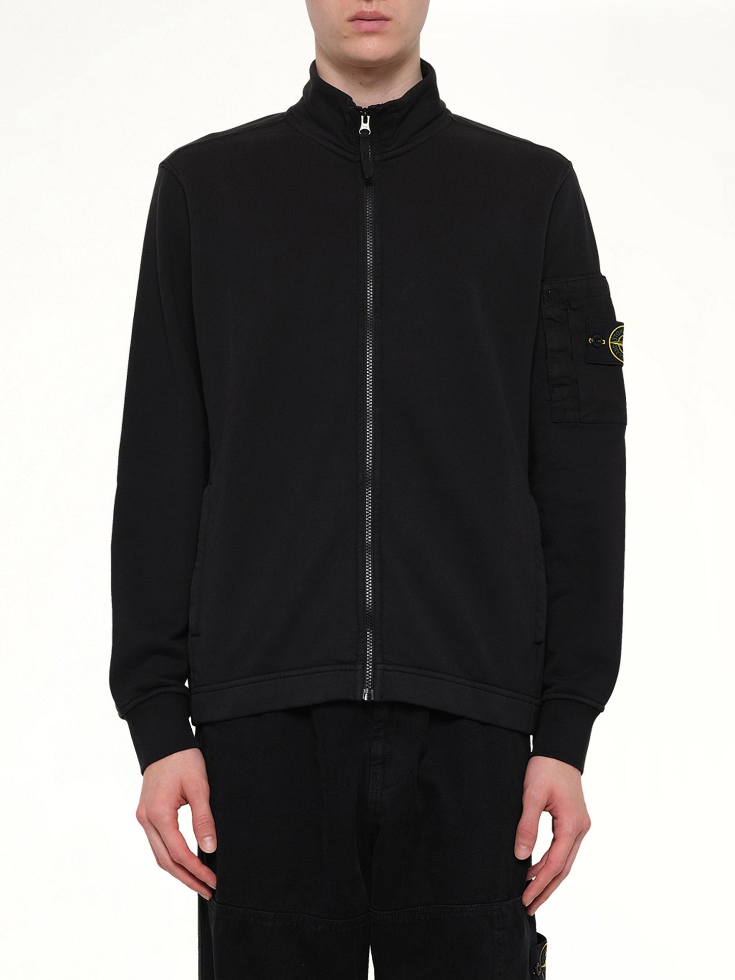 Image of a model wearing Outerwear. Product name - 6100018 Zip Up Cardigan in Black colour by brand - STONE ISLAND