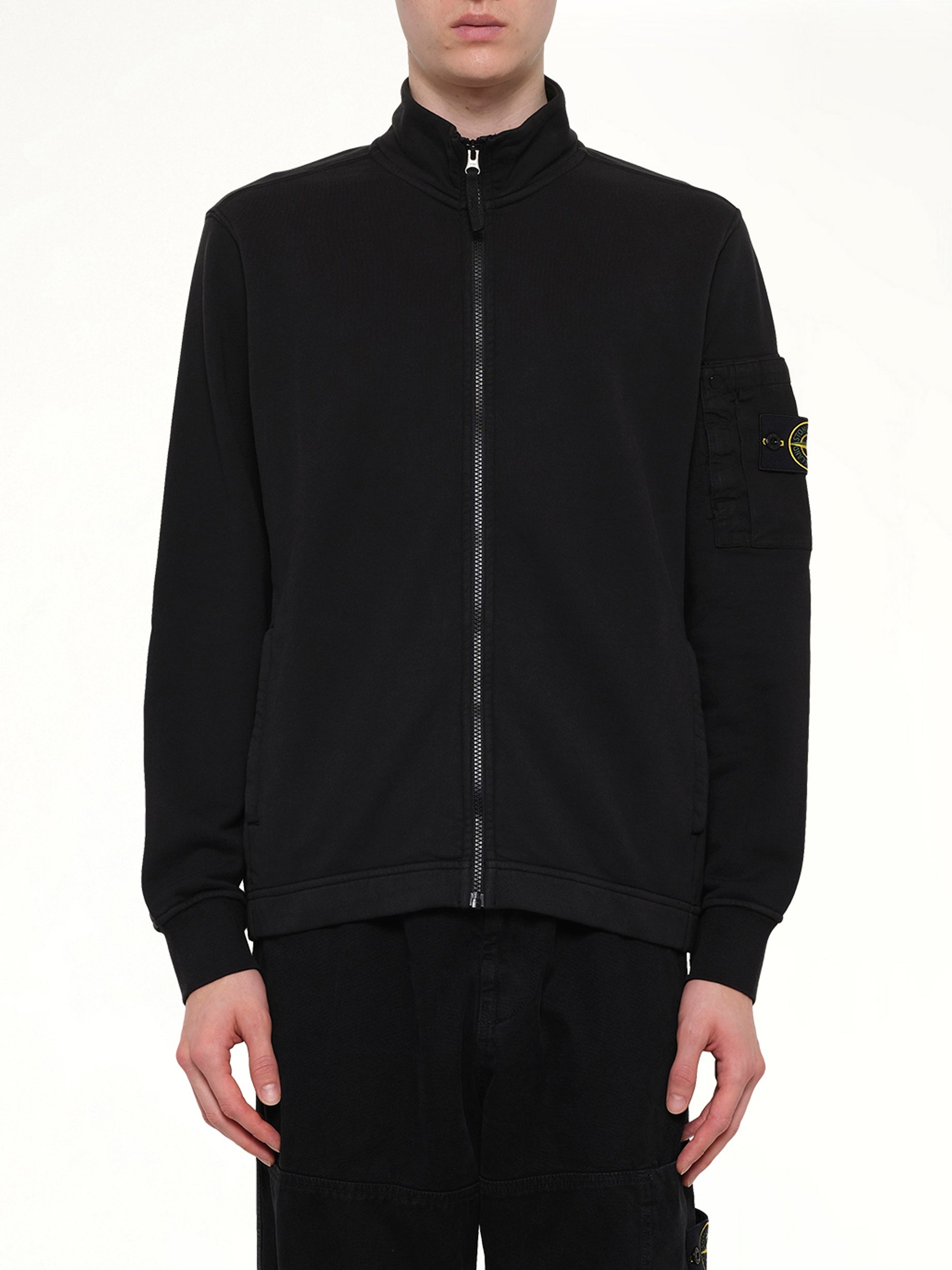 Image of a model wearing Outerwear. Product name - 6100018 Zip Up Cardigan in Black colour by brand - STONE ISLAND