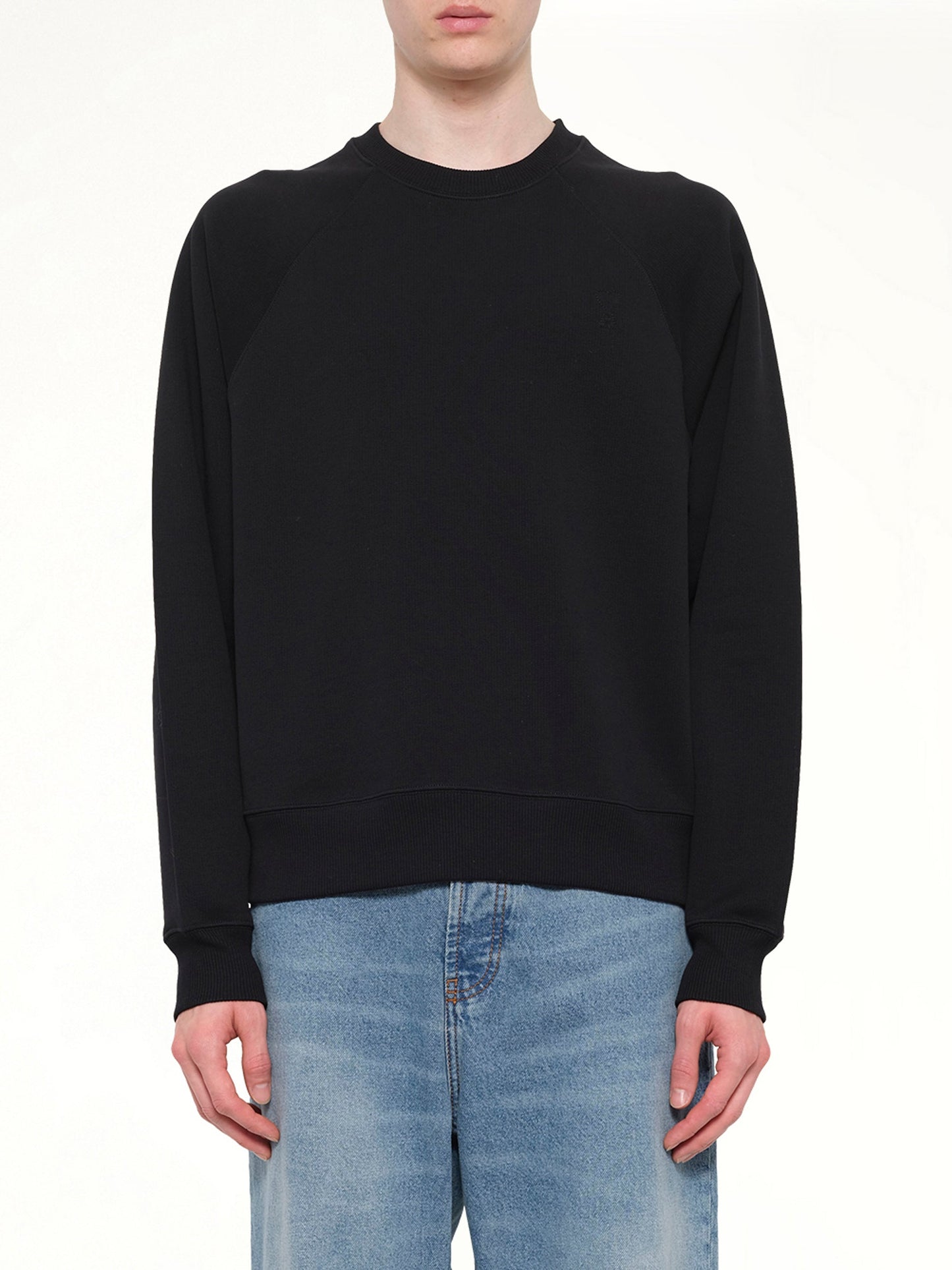 Image of a model wearing Outerwear. Product name - Small Embossed ADC Sweatshirt in Black colour by brand - AMI PARIS