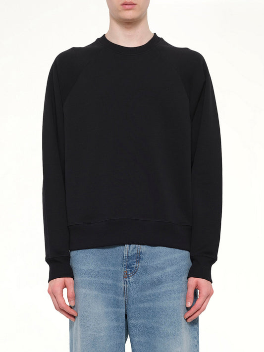 Image of a model wearing Outerwear. Product name - Small Embossed ADC Sweatshirt in Black colour by brand - AMI PARIS