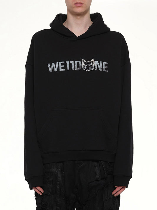 Image of a model wearing Outerwear. Product name - Amber Logo Hoodie in Black colour by brand - WE11DONE