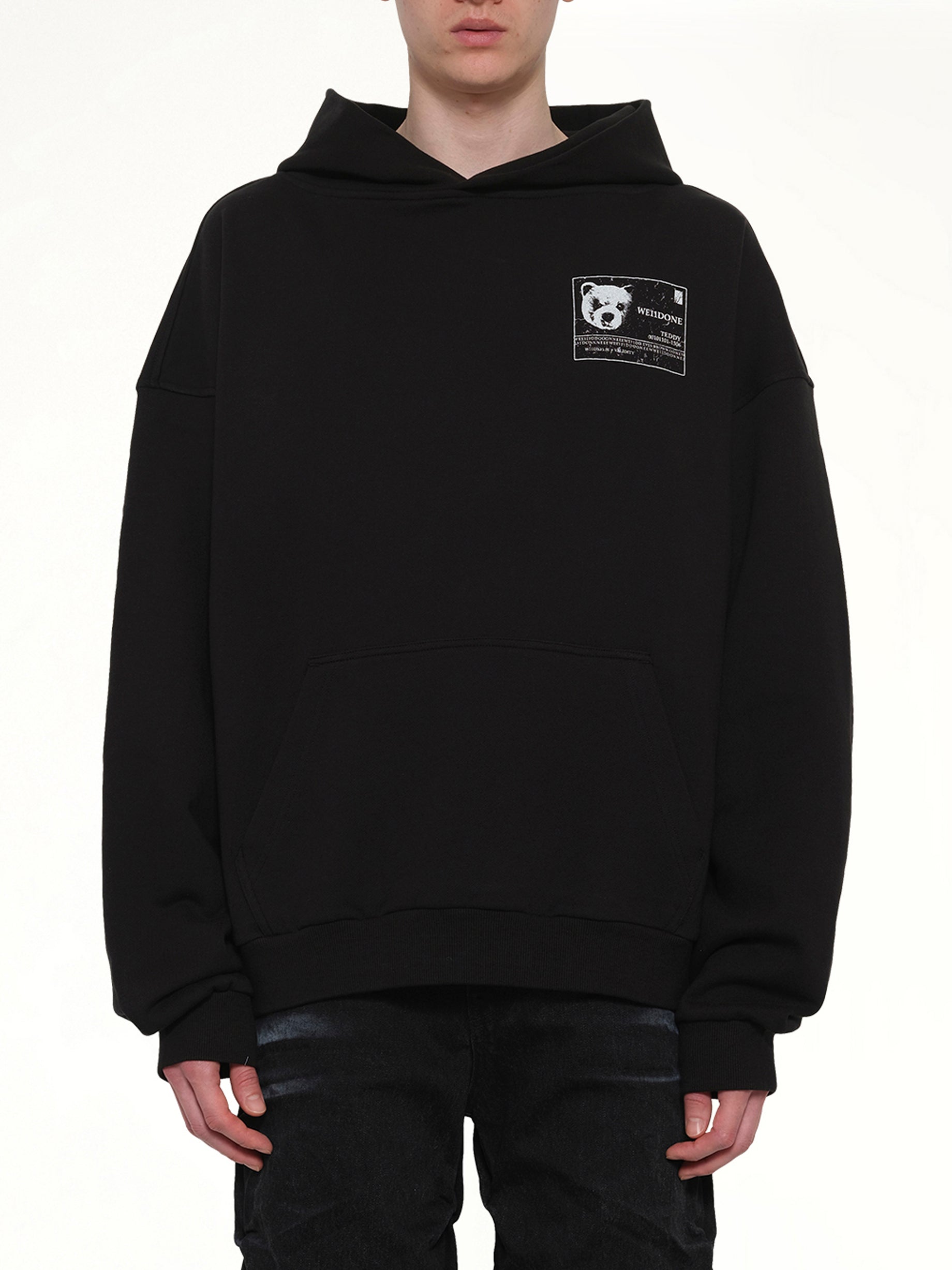 Image of a model wearing Outerwear. Product name - DNA Teddy ID Hoodie in Black colour by brand - WE11DONE