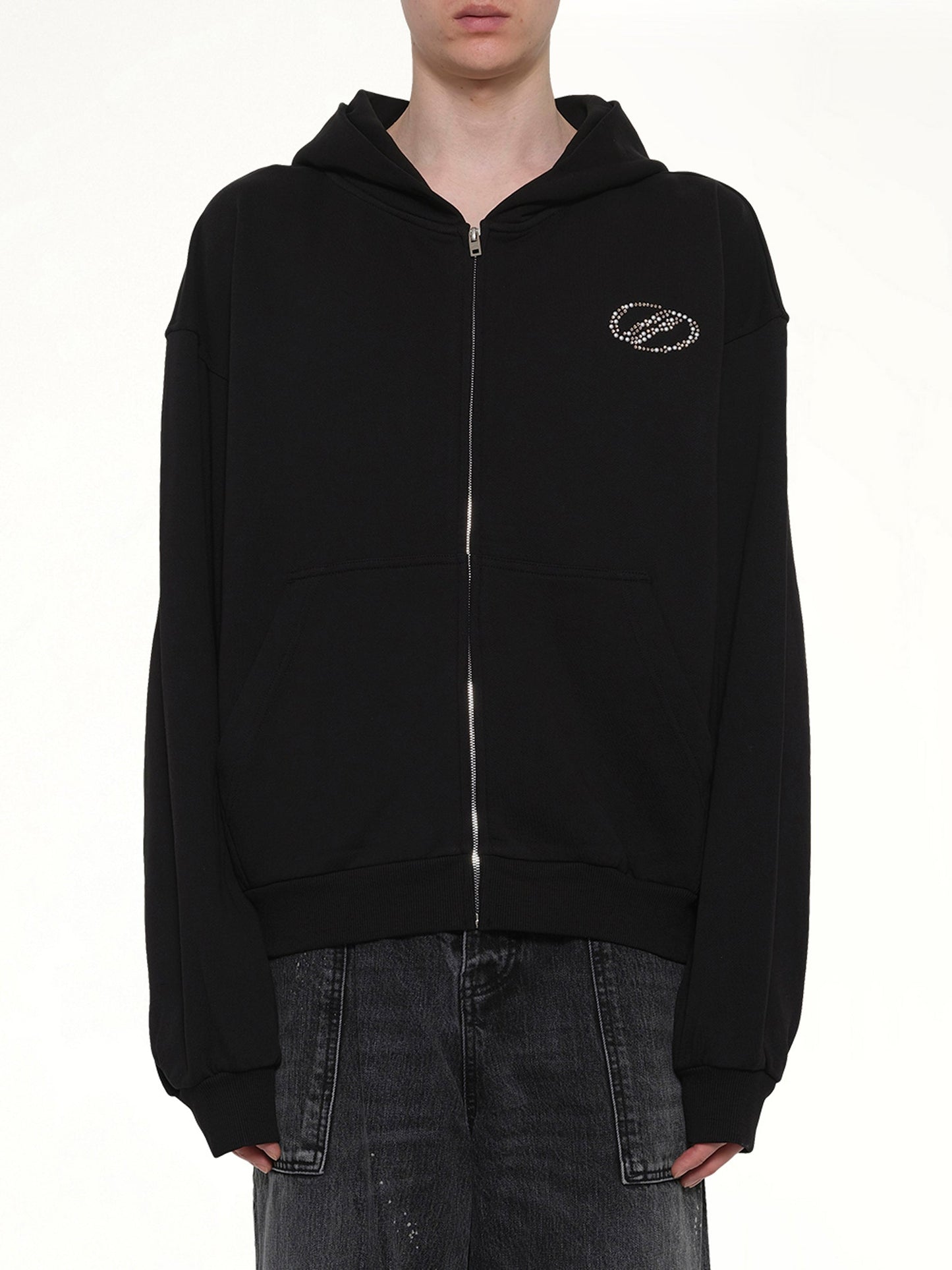 Image of a model wearing Outerwear. Product name - Rhinestone Zip-Up Balloon Hoodie in Black colour by brand - WE11DONE