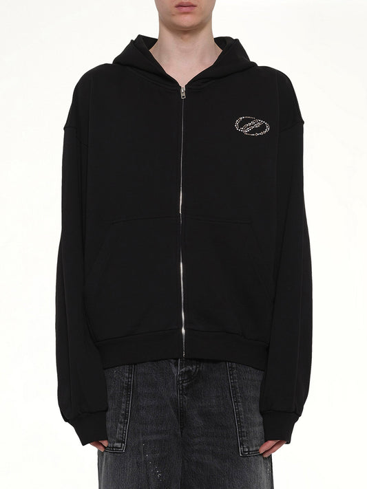 Image of a model wearing Outerwear. Product name - Rhinestone Zip-Up Balloon Hoodie in Black colour by brand - WE11DONE