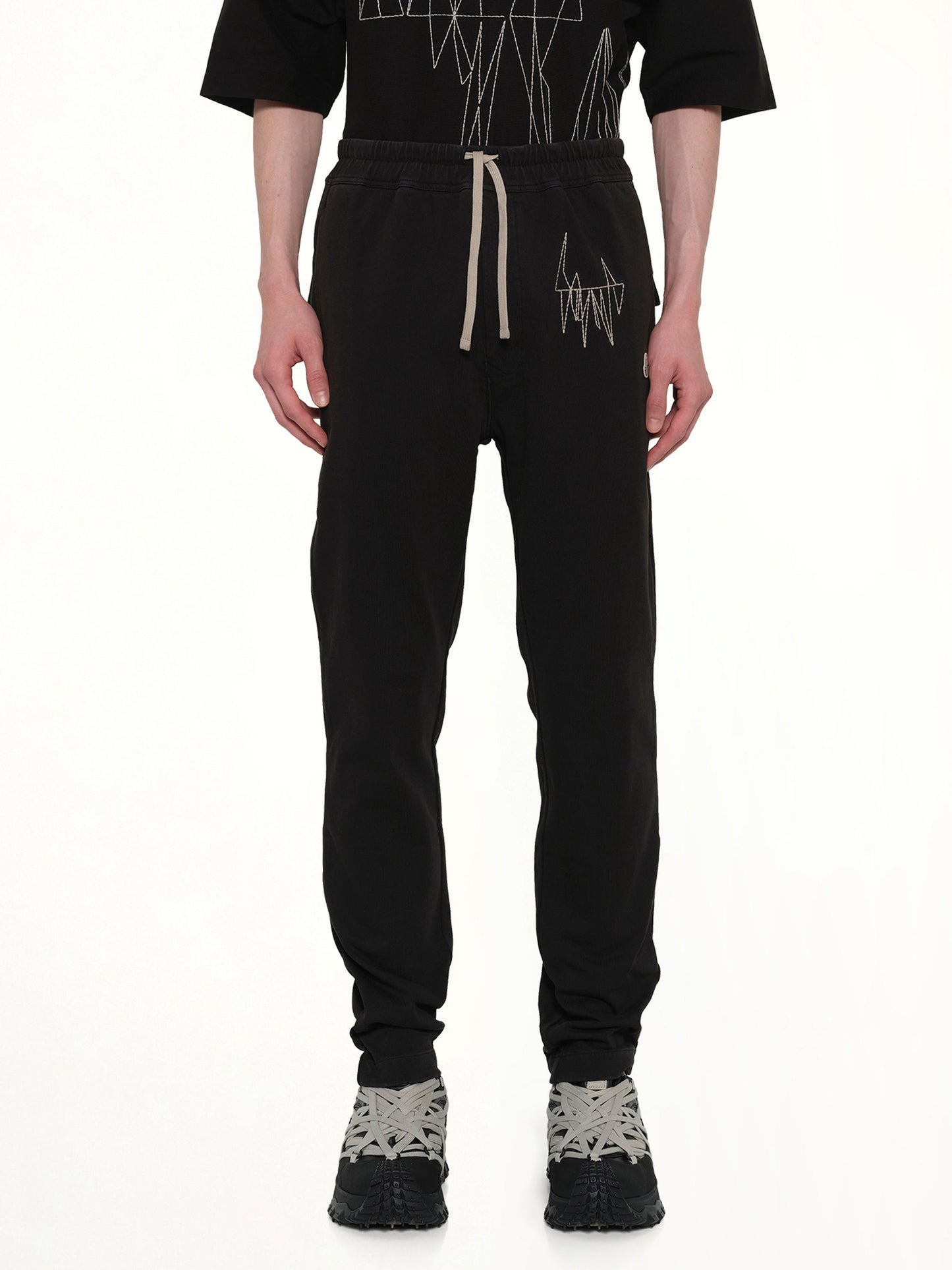 Image of a model wearing Pants. Product name - Rick Owens x Moncler Jogger in Black colour by brand - RICK OWENS