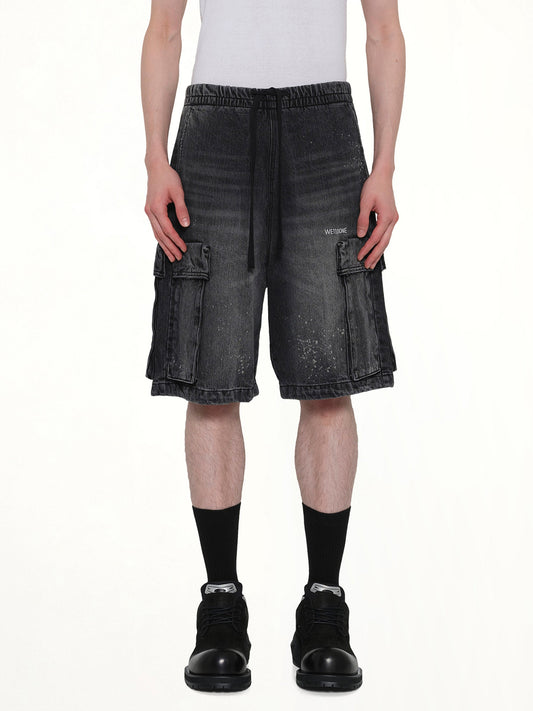 Image of a model wearing Shorts. Product name - Pocket Shorts in Black colour by brand - WE11DONE