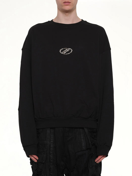 Image of a model wearing Outerwear. Product name - Rhinestone Balloon-Fit Sweatshirt in Black colour by brand - WE11DONE
