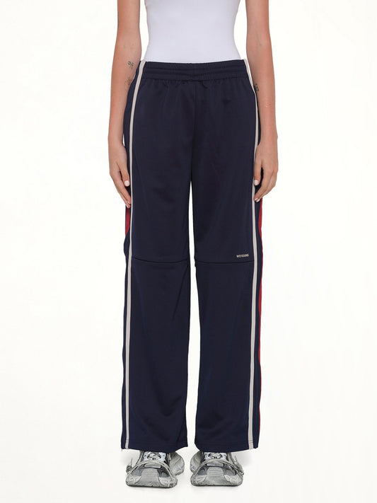 Image of a model wearing Pants. Product name - Track Trousers in Navy colour by brand - WE11DONE