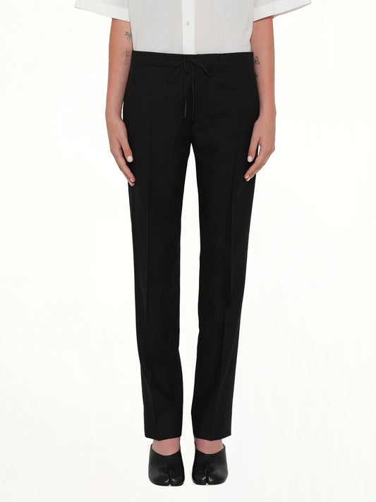 Image of a model wearing Pants. Product name - Wool Flannel Pants in Black colour by brand - MAISON MARGIELA
