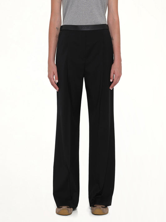Image of a model wearing Pants. Product name - Wool Trouser in Black colour by brand - LOEWE