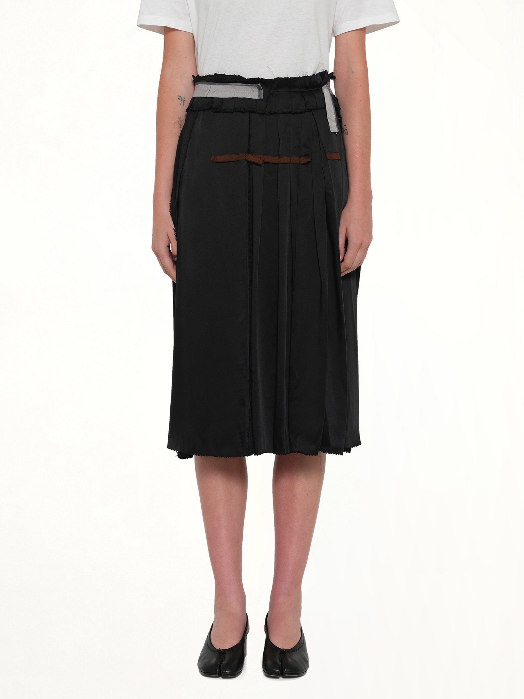 Image of a model wearing Skirts. Product name - Layered Skirt in Black colour by brand - MAISON MARGIELA