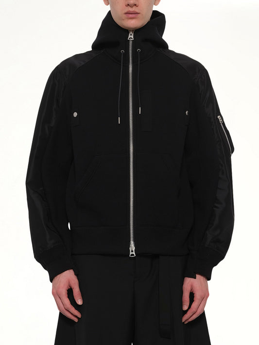 Image of a model wearing Outerwear. Product name - Sponge Sweat Hoodie in Black colour by brand - SACAI