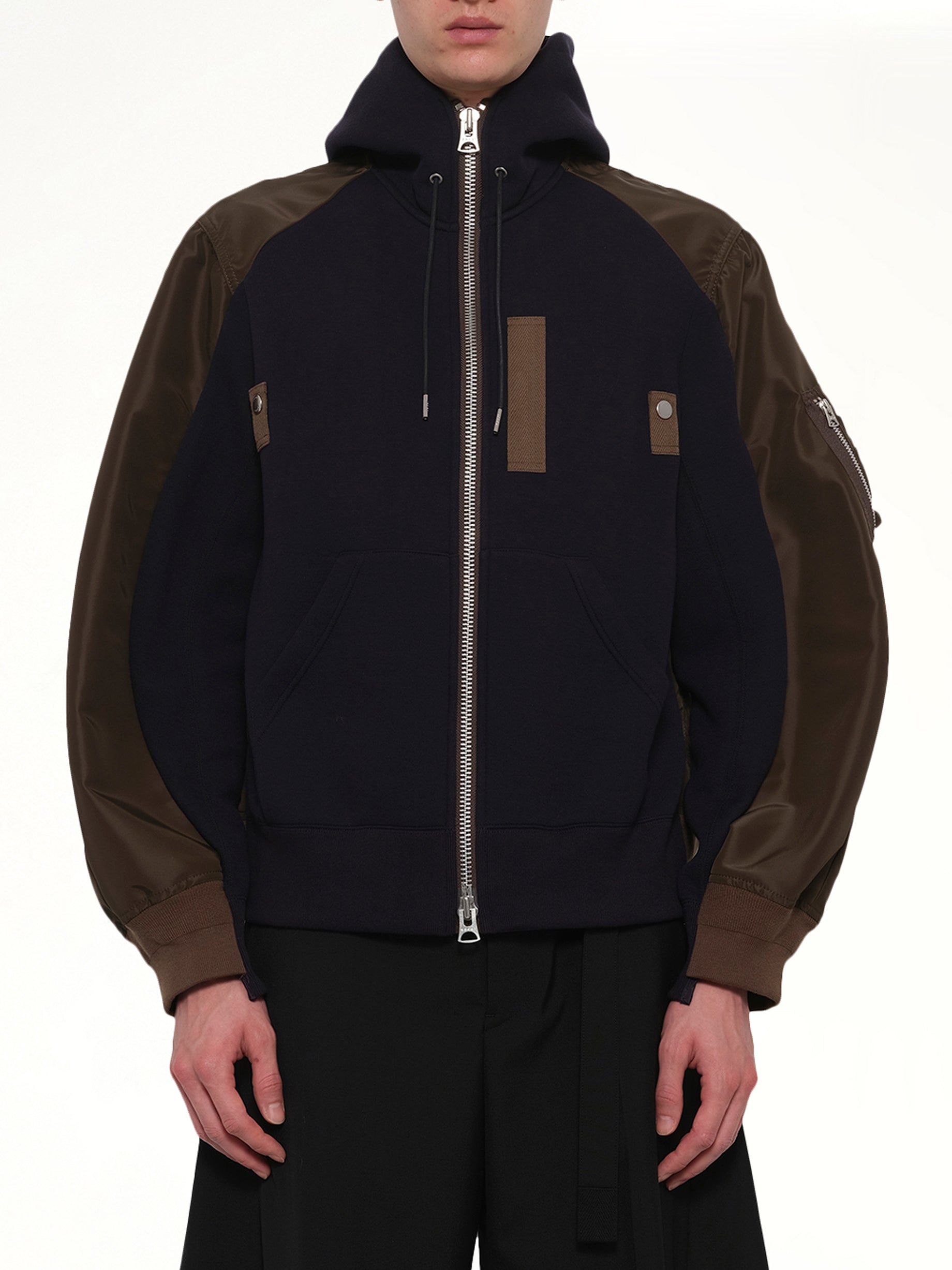 Image of a model wearing Outerwear. Product name - Sponge Sweat Hoodie in Navy colour by brand - SACAI